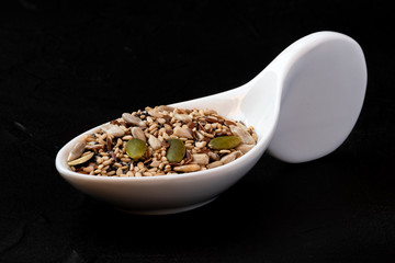 Sesame seeds next to different fruit seeds