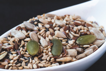 Sesame seeds next to different fruit seeds