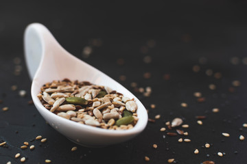 Sesame seeds next to different fruit seeds