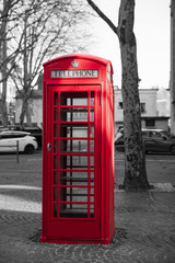 Fototapeta na wymiar Red English style telephone booth on a square in the city of Arras in France with 