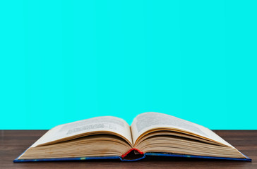 open book on the surface on a blue background