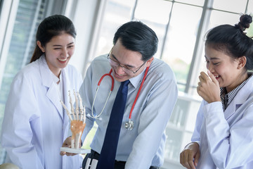 Asian teacher has teaching to student about science and anatomical in laboratory