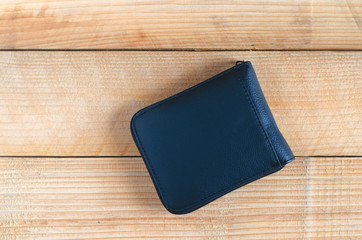 modern black leather wallet on wooden table background. wealth, saving, money, finance and investment concept.
