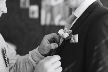 the morning of the groom, a handsome guy in a suit with a bow tie