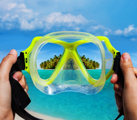 Snorkeling diving mask and tropical island view