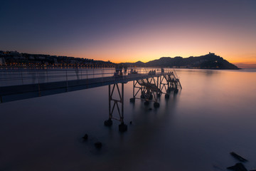 Fototapeta na wymiar Sunset at La Concha (Kontxa) bay at Donostia-San Sebastian, Basque Country. 