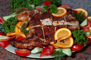 Roasted chicken  stuffed with mushrooms, pepper and corn, garnished with .fresh vegetables, orange and herbs