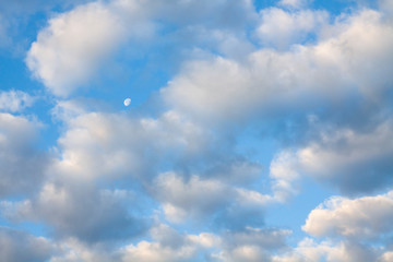Blue summer sky white cumulus clouds and moon