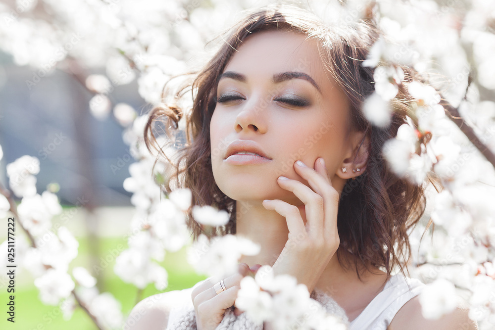 Wall mural attractive young woman on spring background. beautiful lady outdoor. closeup portrait of young brune