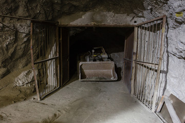 Underground gold ore mine shaft tunnel gallery passage with load, haul, dump machine LHD