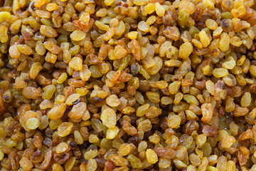 Pile of dry raisins of light brown color