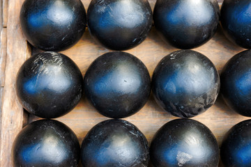Three rows of vintage iron cannon balls