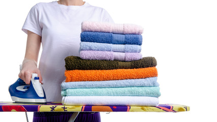 Woman ironing laundry towels on iron board on white background isolation