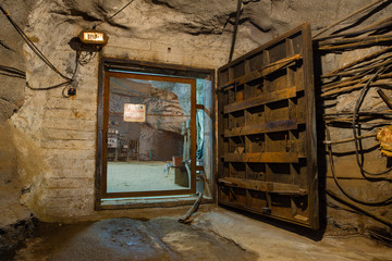 Underground gold ore mine shaft tunnel gallery passage with massive gates