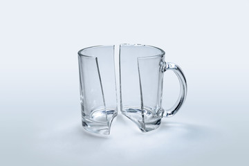Broken glass cup in half on white background