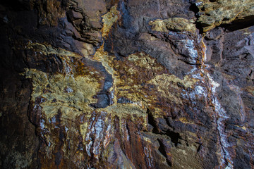 Underground gold ore mine shaft tunnel gallery with sulfur specimen