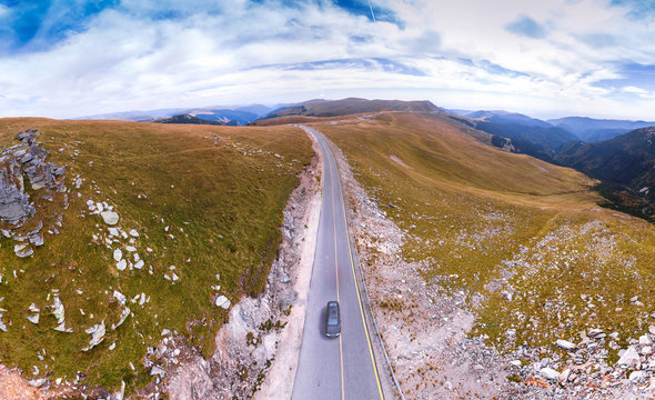 Aerial view on transalpina, cars on road on Romania mountain, travel, adventure concept, motorcyclists way, vacation place, mountains top, autumn day