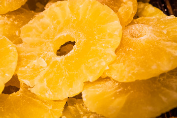 Bright yellow background or texture. Tropical dried fruit the pineapple cut on rings. Summer and exotic. Vitamins and useful fruit