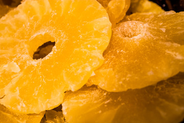 Bright yellow background or texture. Tropical dried fruit the pineapple cut on rings. Summer and exotic. Vitamins and useful fruit