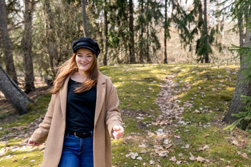  Beautiful girl in a coat runs through the woods. Happiness, freedom, zen concept