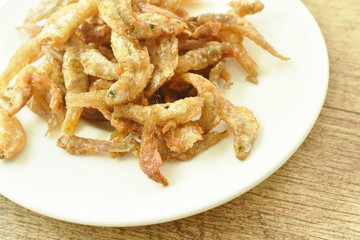 crispy fried anchovy fish with salt on plate