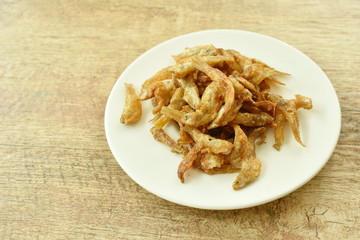 crispy fried anchovy fish with salt on plate