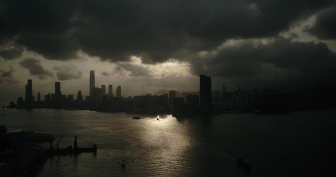 Aerial drone shot of Hong Kong harbour at sunset with clouds. Financial district in Asia. China. DJI Inspire 2 X7  