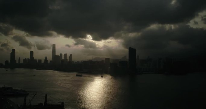 Drone sunset aerial shot of Hong Kong Island modern skyscraper high-rises. Hong Kong is a center of finance business in China. Asia. Reflection on water.