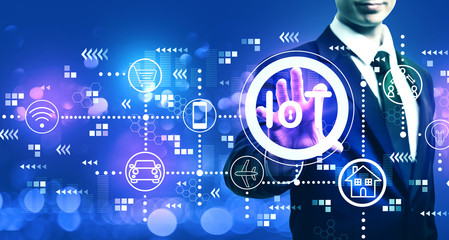 IoT theme with businessman on blurred blue light background