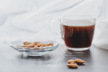 Concept of helathy snack - almonds with coffee