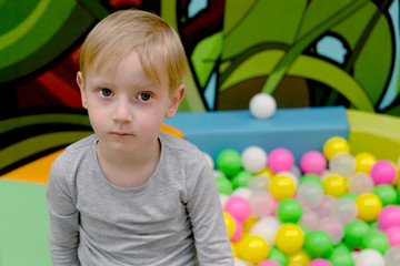 Fototapeta na wymiar Four year old boy playing at new playground kindergarten. Four y