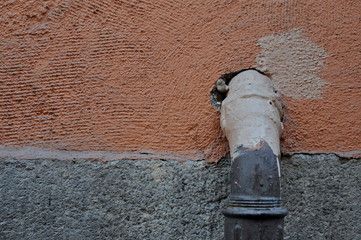 pipe in a street in a coral background wall