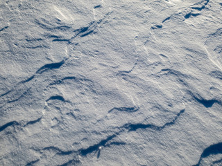 Fototapeta premium Patterns in the snow after a blizzard. Snow after a blizzard. Snow drift.