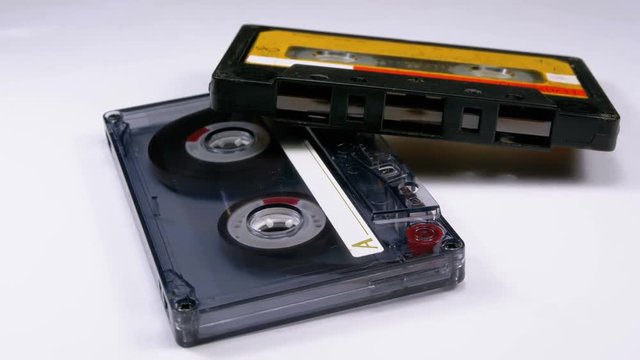 Two Vintage Audio Cassette Rotates on White Background