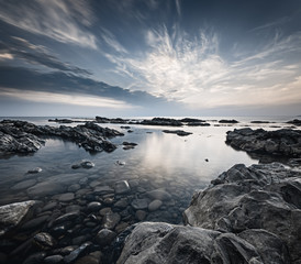 Dramatic seascape with rocky shore