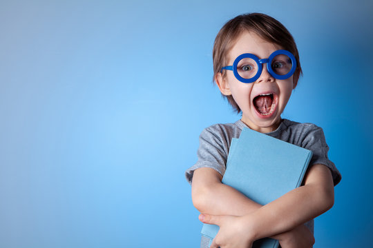  Portrait of a handsome preschooler boy with glasses.