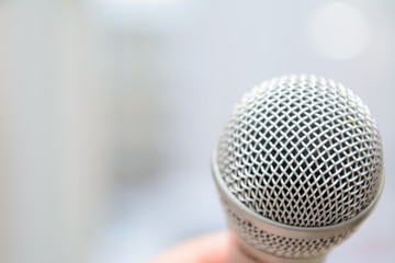 studio microphone on a blurred background in male hand