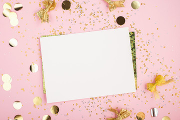 Blank sheet of paper, notebook on a festive pink background with golden confetti and glitter. Universal background for a project of a birthday party, wedding. Flay lay, copy space