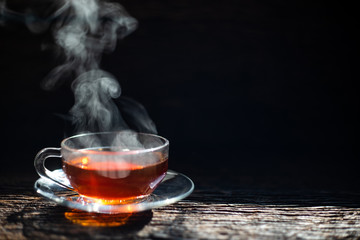 Hot tea cup in a glass on wood background.Hot drink . Copy space.
