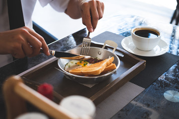 A man eating a healthy morning meal, breakfast at cafe. Businessman with breakfast.