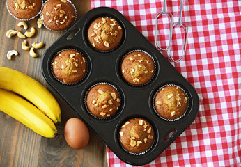 A lot of banana muffin or banana cup cake topping with cashew nut