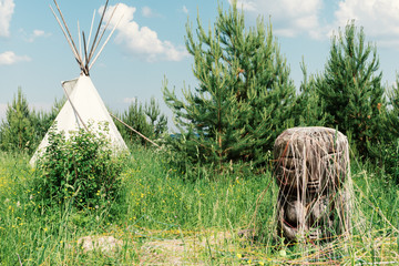 Ancient deity of earth and fertility of the Pachamama in the backdrop of the Indian wigwam. © Elena