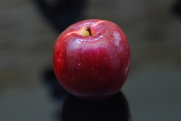 red apple on black background