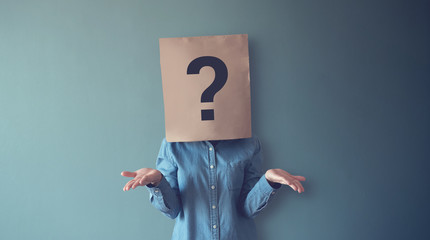Woman has Confused, Thinking, Question Mark Icon on Paper Bag, copy space. - obrazy, fototapety, plakaty