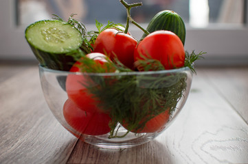 tomatoes with cucumber on wooden background