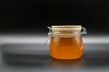 Bank of honey on a dark background