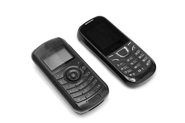 Push-button phones of the older generation on isolated background . Mobile technology development