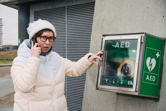 medicine cardiopulmonary resuscitation emergency call. Caucasian woman uses telephone calling 911 help. device box aed automatic defibrillator diseases, death, cardiac arrest and heart attack
