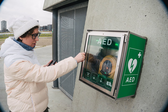 medicine cardiopulmonary resuscitation emergency call. Caucasian woman uses telephone calling 911 help. device box aed automatic defibrillator diseases, death, cardiac arrest and heart attack