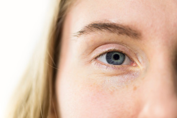 blue eye pupil closeup on white background